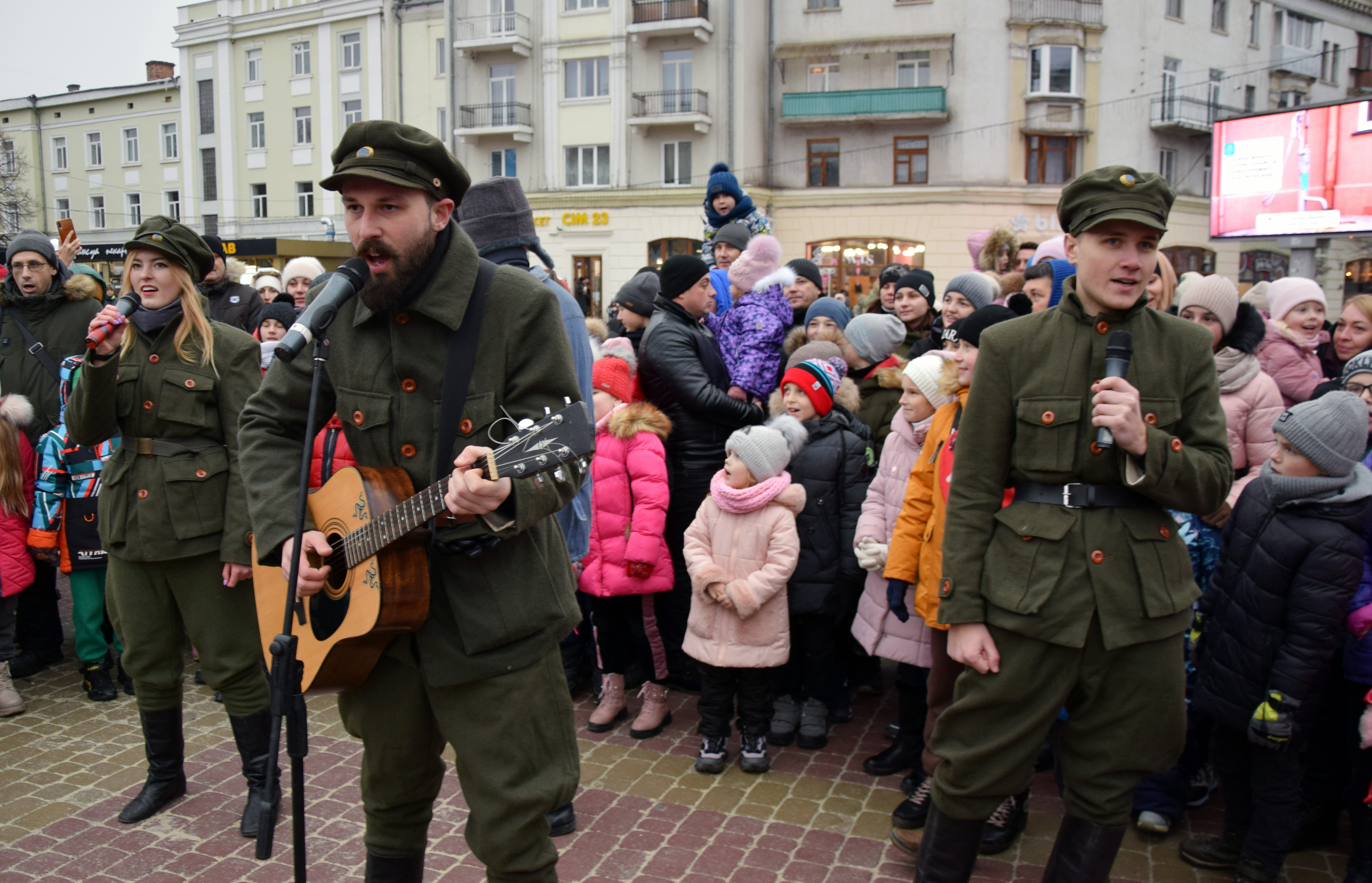 (Зліва направо) учасники клубу історичної реконструкції «Патріот» Інна Макух, Борис Шамчук та Олексій Осьмак в одностроях воїнів УПА співають разом з учасниками казкового дійства пісню «Ой, у лузі червона калина»